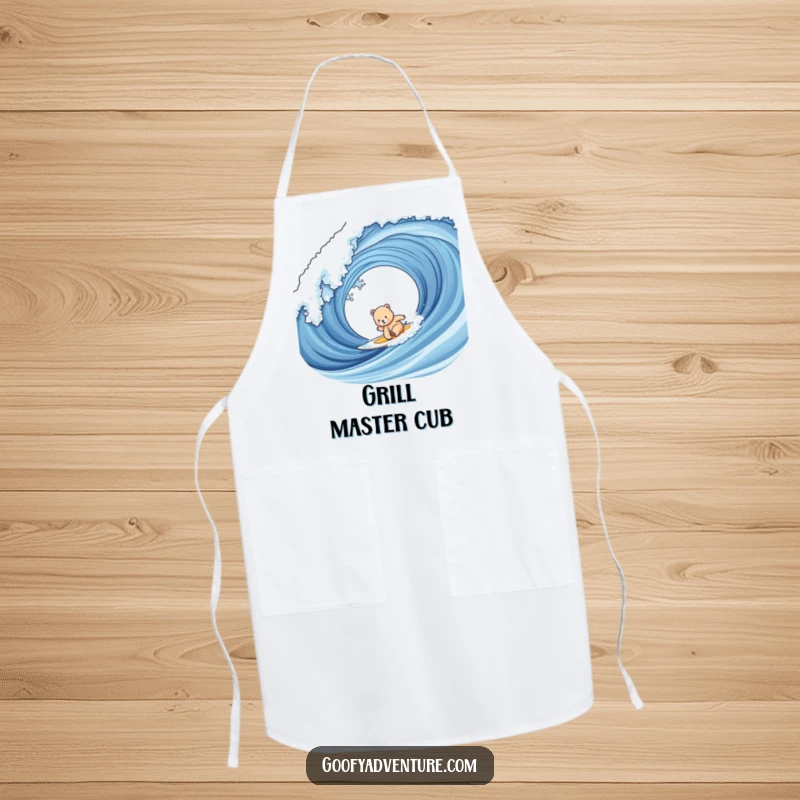 Funny bear cub surfing apron showing a cute cub on a surfboard riding a giant wave, ready for a beach BBQ.