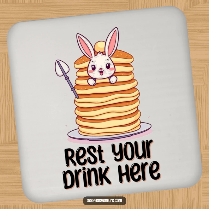Funny Bunny coaster, bravely scaling a colossal, wobbly stack of pancakes, protecting surfaces with adventurous style.
