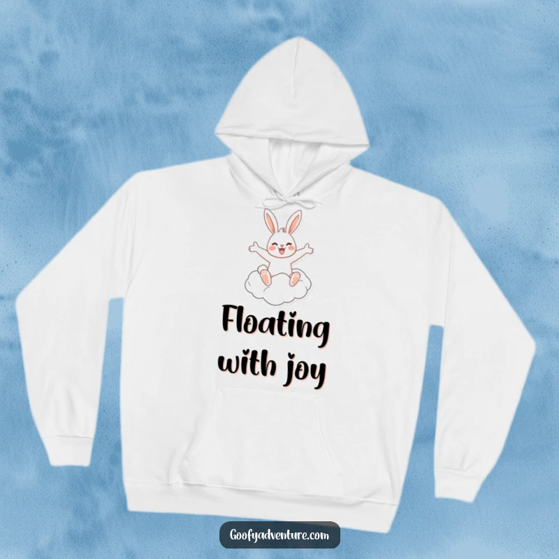 A warm and cozy hoodie illustrating a funny, cheerful rabbit riding a flying cloud with arms spread wide in delight.