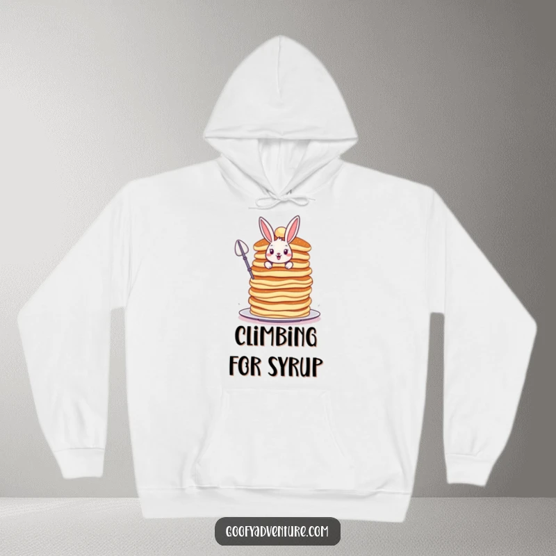 Funny Bunny hoodie, bravely scaling a colossal, wobbly stack of pancakes, cozy apparel for the brave.