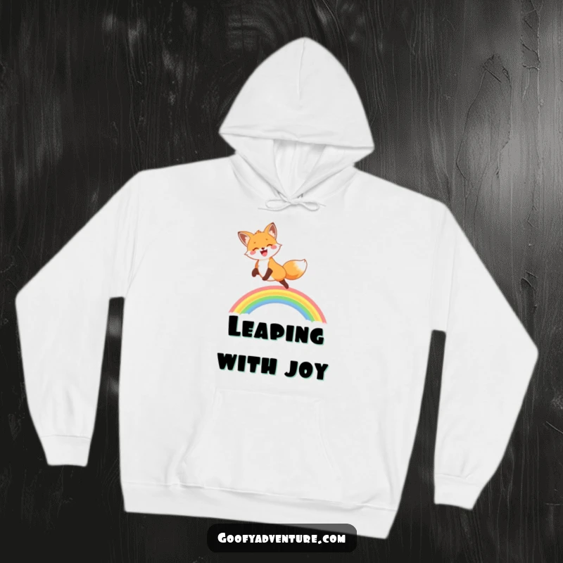 A cozy hoodie featuring a funny, joyful fox leaping over a bright rainbow, symbolizing happiness and adventure.