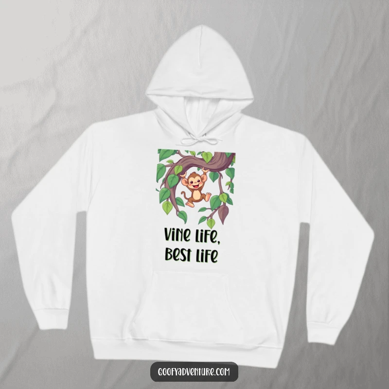 Funny cozy hoodie with a cheerful monkey character swinging gleefully from a giant, whimsical jungle vine.
