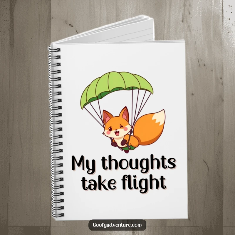 Funny fox character paragliding with a giant leaf parachute, depicted on a notebook cover for jotting down adventurous thoughts.