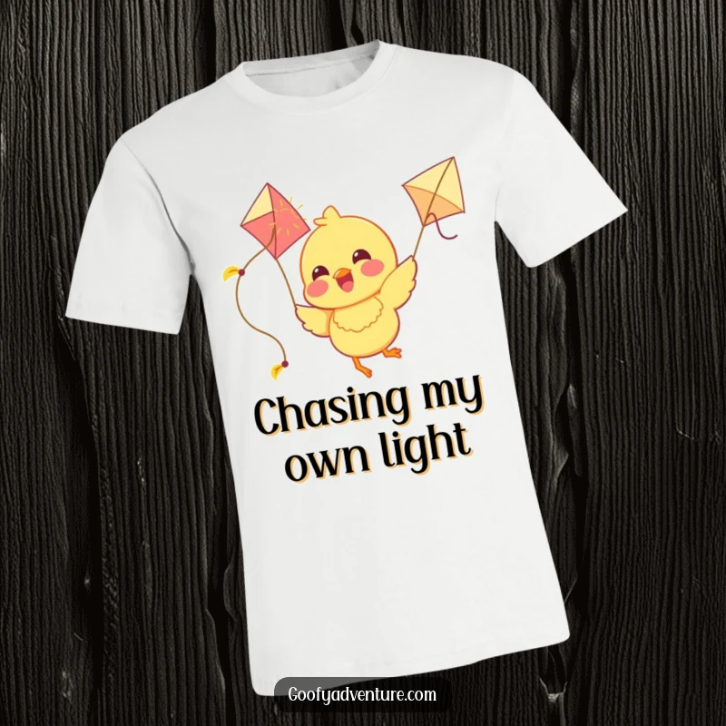 Funny Chick T-Shirt: A joyous chick soars through the sky, flying a kite crafted from bright sunshine, exuding pure happiness.