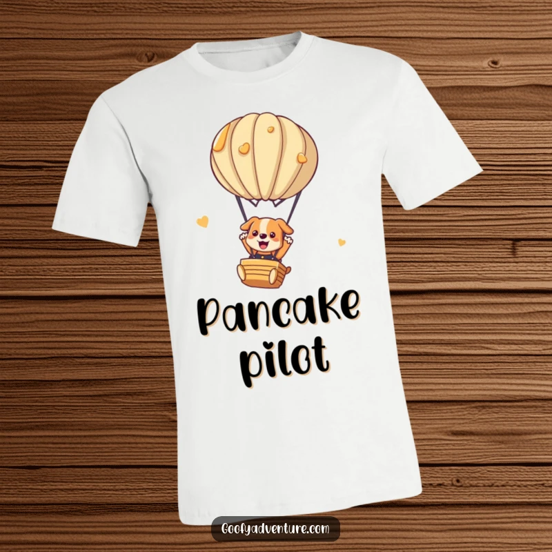 Funny dog t-shirt showing a playful dog parachuting from a hot air balloon crafted from stacked pancakes. Hilarious and unique.