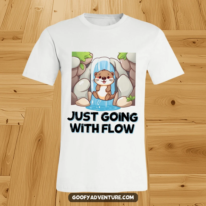 A comfortable t-shirt featuring a funny, playful otter sliding gleefully down a waterfall entrance, ready for fun.